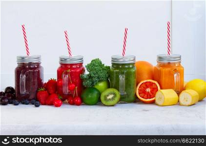 Colorful smoothy drinks in glass jars with igredients. Fresh smoothy drink with igredients