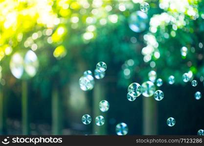 Colorful soap bubbles outdoors, summer time, fun
