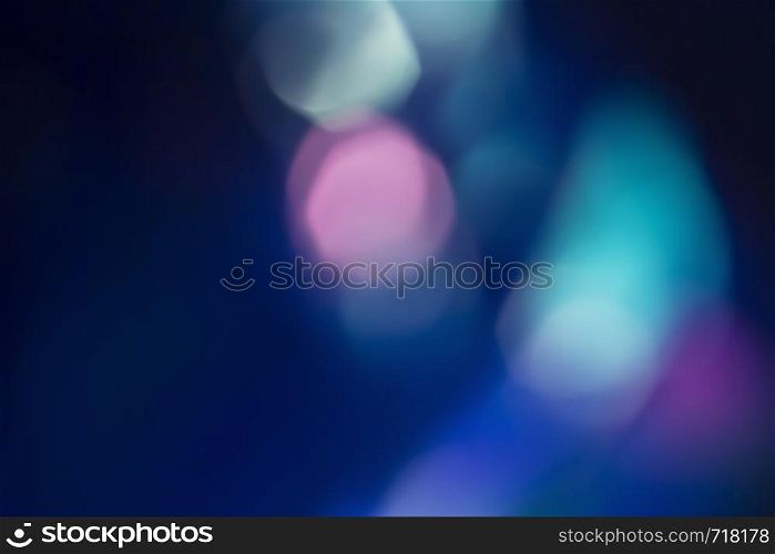 Colorful soft circular bokeh overlay for use to enhance images with copy space on a deep twilight blue background. Colorful soft circular bokeh overlay