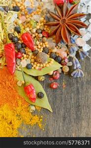 Colorful spices and herbs on old wood