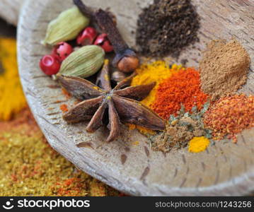 colorful spices with anise in a wooden spoon