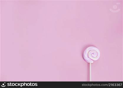 Colorful spiral lollipop on pink background top view, hard candy, sugar sweets concept copy space space for text. Colorful spiral lollipop on pink background top view, hard candy, sugar sweets concept copy space