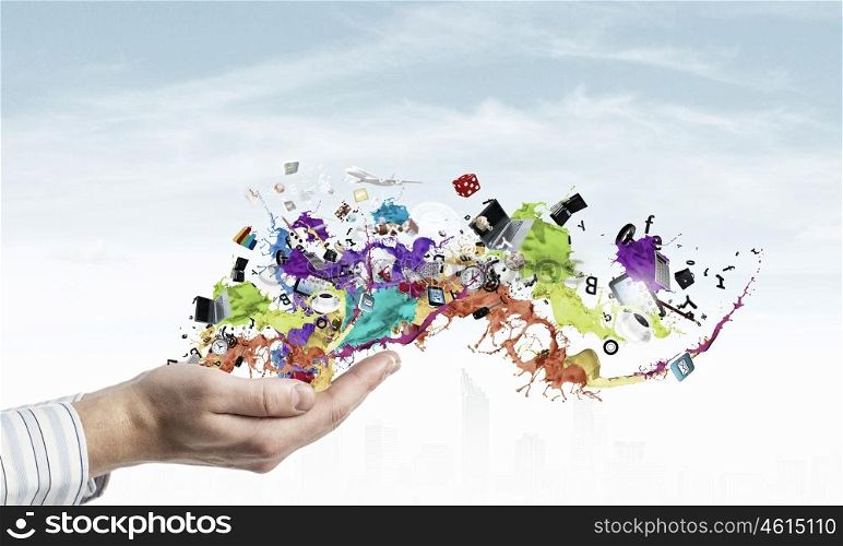 Colorful splashes in palms. Male hands with paint splashes and icons in palms
