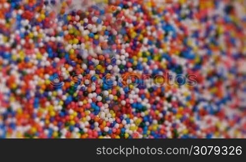 Colorful sprinkles sugar candy pouring down