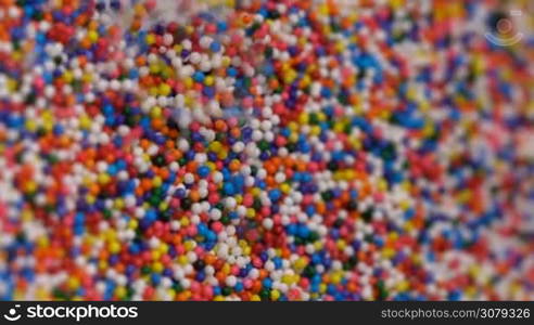 Colorful sprinkles sugar candy pouring down