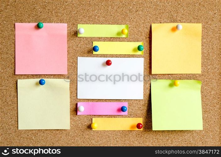 Colorful sticky notes on cork board background