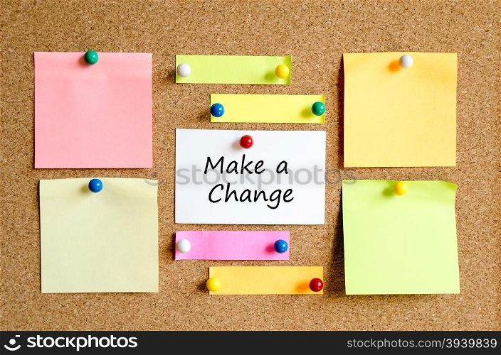 Colorful sticky notes on cork board background and text concept make a change