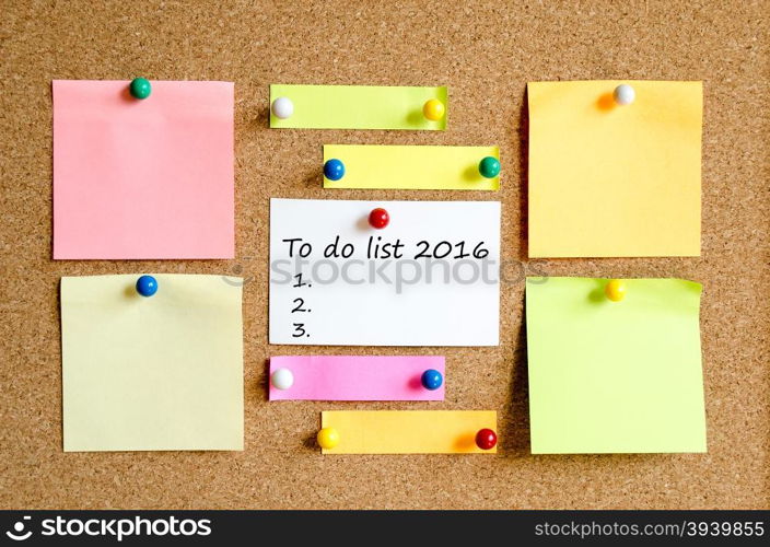 Colorful sticky notes on cork board background and text concept to do list 2016