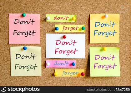 Colorful sticky notes on cork board background don&rsquo;t forget concept