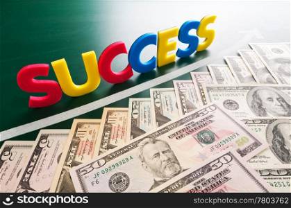Colorful success words and growing US dollars on blackboard