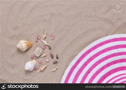 Colorful summer female fashion outfit flat-lay on sand. Summer fashion or holiday travel concept