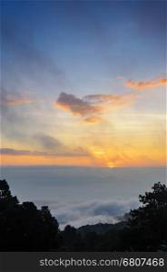 Colorful sunrise above the clouds from high mountain at viewpoint Huai Nam Dang national park in Chiang Mai and Mae Hong Son province of Thailand
