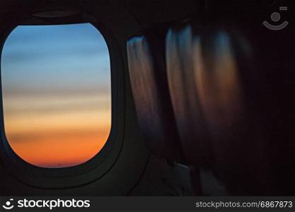 colorful sunrise in airplane window