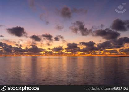 Colorful sunrise over tropical ocean on Maldives