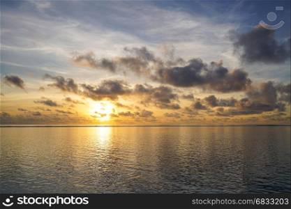 Colorful sunrise over tropical ocean on Maldives
