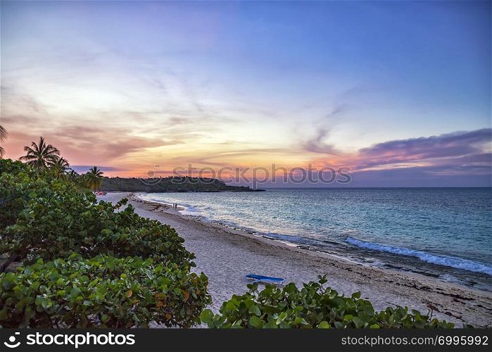 Colorful sunset and peaceful ocean wave at the Guardalavaca beach in Cuba. Perfect resort for relaxing.