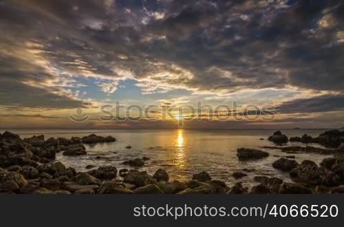 Colorful sunset on sea in rocks bay time lapse