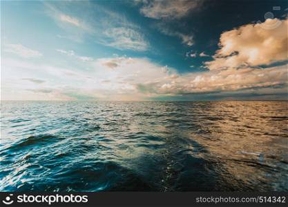 Colorful sunset over evening sea horizon, clouds sky. Tranquil scene. Natural background. Landscape. View from yacht. Beautiful sunset on the ocean sea