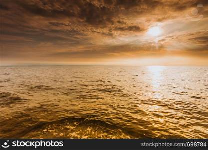 Colorful sunset over evening sea horizon, clouds sky. Tranquil scene. Natural background. Landscape. View from yacht. Beautiful sunset on the ocean sea