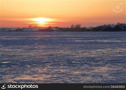 Colorful sunset over frozen lake