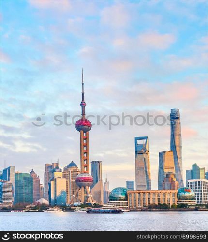 Colorful sunset over Shanghai metropolis embankment with buildings of modern architecture, skyscrapers and famous tv tower, China