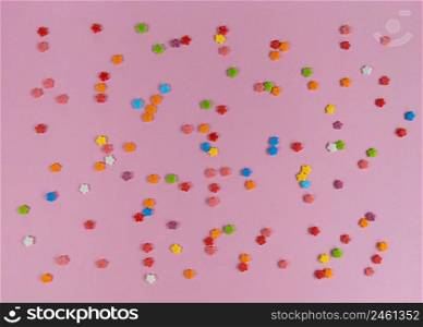 Colorful sweet confetti flowers on a pink backgroud.. Colorful sweet confetti flowers on pink backgroud.