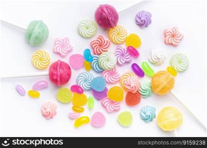 Colorful sweet lollipops and candies over white background.  Flat lay, top view