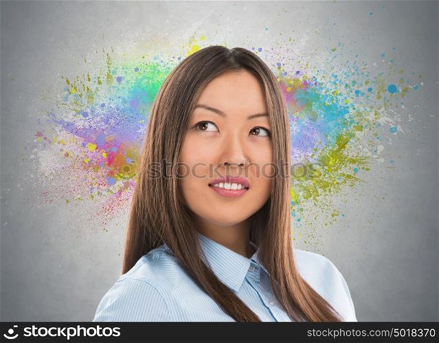 Colorful Thinking. Business woman against gray background and colorful splashes