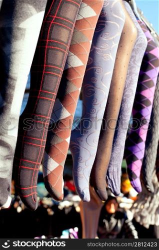 colorful tights in a row hanging in an outdoor market