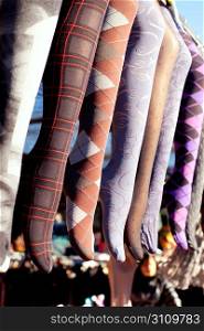 colorful tights in a row hanging in an outdoor market