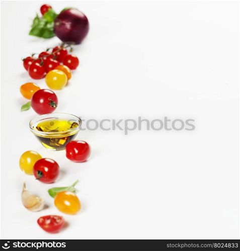 colorful tomatoes and vegetables over white background - Healthy eating, vegetarian or cooking concept