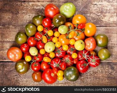 colorful tomatoes on wooden table