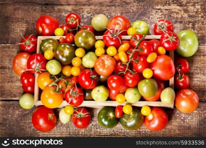 colorful tomatoes on wooden table