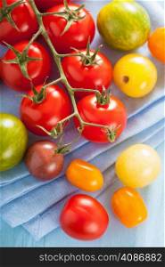 colorful tomatoes over blue napkin