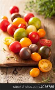 colorful tomatoes over wooden background