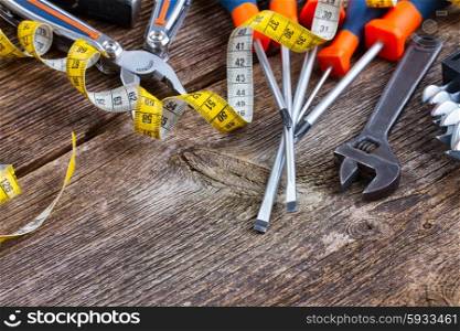 colorful tools kit on wooden aged background. tools kit frame on wooden planks