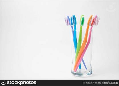 colorful toothbrushes in glass