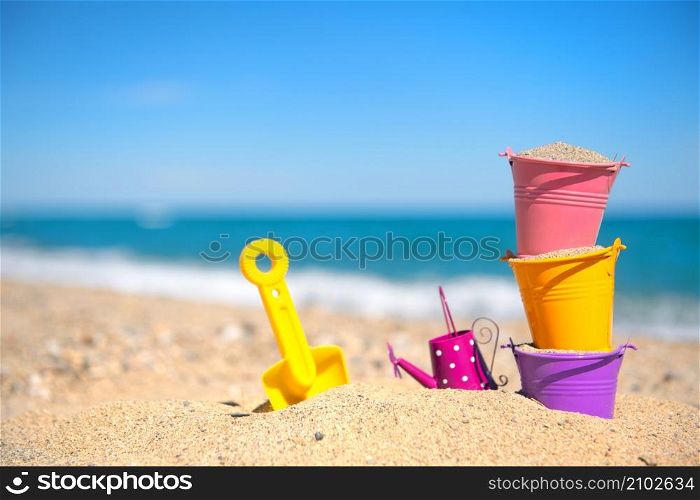 Colorful toy buckets at the beach
