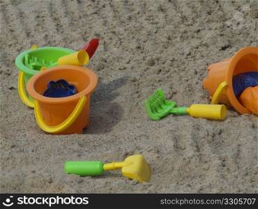 colorful toys lying scattered in a sandbox