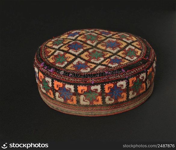 colorful traditional asian skullcap cap on a dark background. traditional asian skullcap