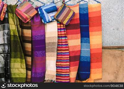 Colorful traditional Moroccan scarves and shawls in many stripes pattern at a shop in Ouarzazate, Morocco.