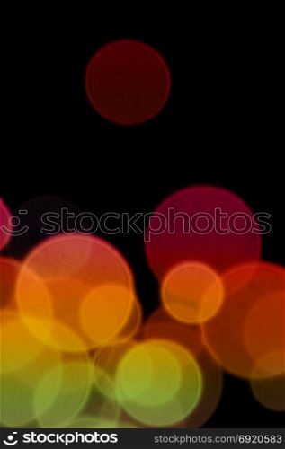 Colorful transparent circles abstract blur on black background. Lights at night.