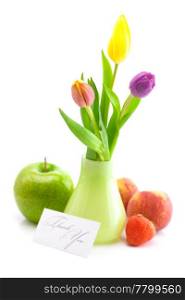 colorful tulips in vase,strawberries,apple,peach and a card signed thank you isolated on white