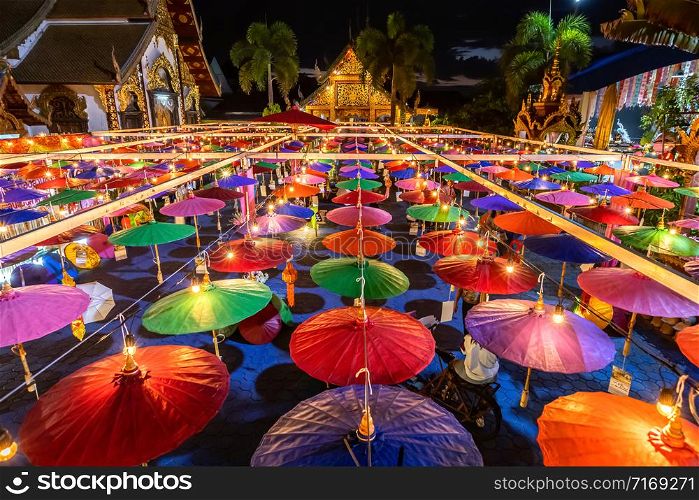 Colorful umbrella and paper vintage lantern for in northern thai style lanterns in Loi Krathong or Yi Peng Festival at Wat Phra Pan (Wat Phra Non Mae Pu Ka) is Buddhist temple in Chiang Mai,Thailand.