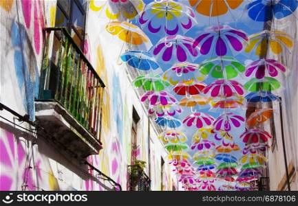 Colorful umbrellas in the sky. Street decoration.Beja, Portugal