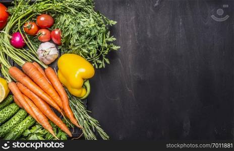 Colorful various of organic farm vegetables in a wooden box on wooden rustic background top view close up border ,place for text