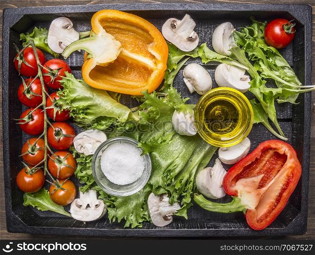 Colorful various of organic farm vegetables in a wooden box on wooden rustic background top view close up