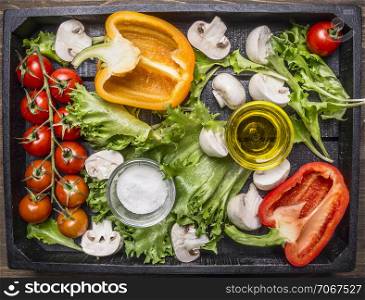 Colorful various of organic farm vegetables in a wooden box on wooden rustic background top view close up