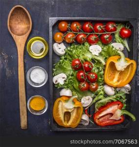 Colorful various of organic farm vegetables in a wooden box with wooden spoon on wooden rustic background top view close up