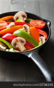 colorful vegetables in black pan ready for frying